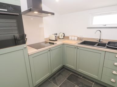 A kitchen with a cooker and kettle at Mys Hedra Farm St Buryan