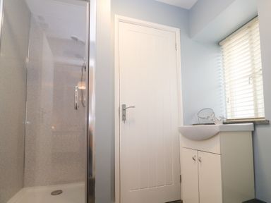 A bathroom with a shower and a basin at Mys Hedra Farm in St Buryan