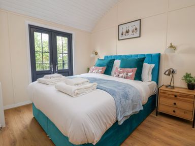 A bedroom with a double bed and folded towels on it at The View in Bangor-On-Dee