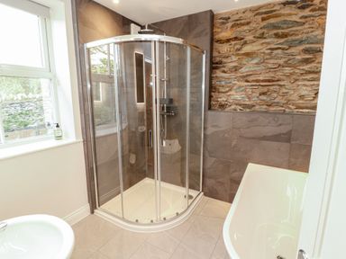 A bathroom with a shower and bathtub at Rothay Cottage Ambleside