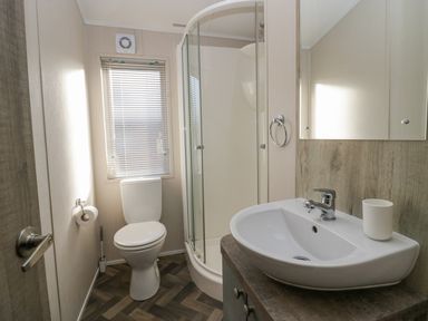A bathroom with a toilet shower and sink at The Three Bears Lodge Coniston Drive 11 South Lakeland Leisure Village near Warton