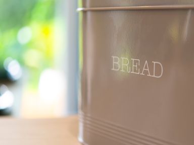 A close up of a brown container labeled bread in a kitchen