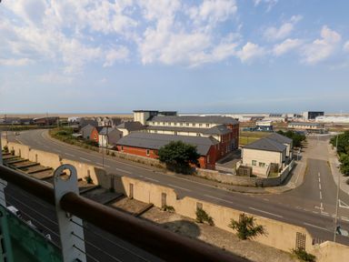 A view of roads and buildings with the sea in the background at Manhattan Beach in Castletown Portland