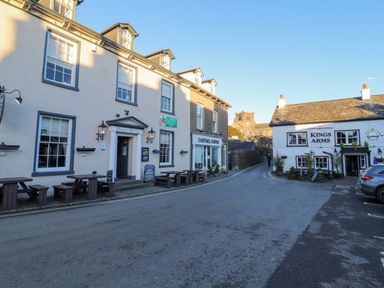 A street view with Priory Hotel and Cartmel Coffee on the left and Kings Arms on the right in Bowland Bridge near Bowness-On-Windermere Lake District