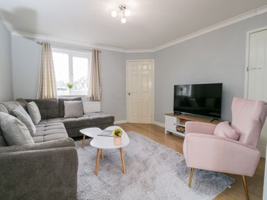 A living room with a sofa and television at 20 Honeycroft Bourton-On-The-Water