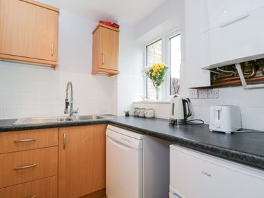 A kitchen with a sink and cabinets at 20 Honeycroft Bourton-On-The-Water