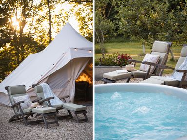 Outdoor scene with two cushioned lounge chairs next to a white tent and a bubbling hot tub at Moonshine in St Erme near Truro