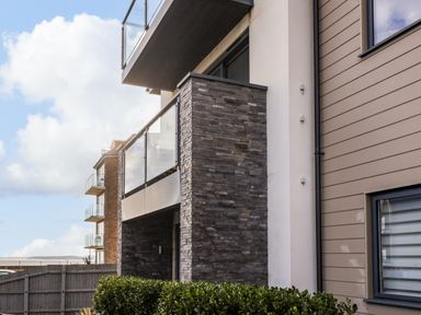 Exterior of a modern building with balconies and glass railings at 7 Warren Edge Close in Bournemouth