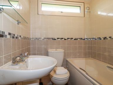 A bathroom with a sink toilet and bathtub near St Merryn