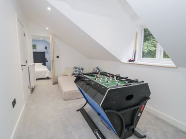 A games room with a foosball table and bed at Frongoch Old Power House in Dolgellau