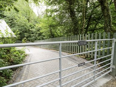 A gate leading to a pathway at Frongoch Old Power House in Dolgellau