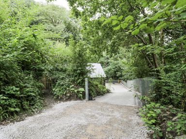 An outdoor area with a path and gate at Frongoch Old Power House in Dolgellau