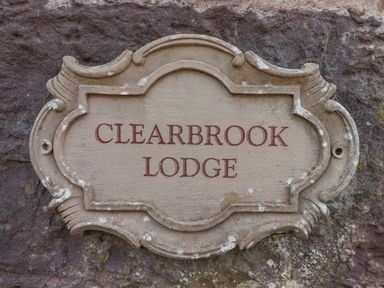A stone plaque with the words Clearbrook Lodge mounted on a stone wall at Clearbrook Lodge in Llanarthney nr Llandeilo Carmarthenshire