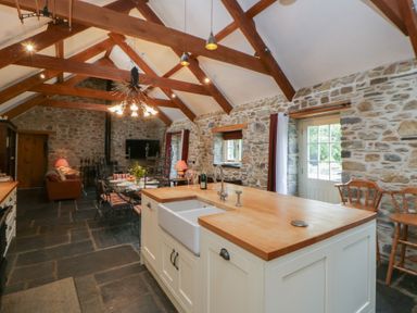 A kitchen with an island and sink at St Dogwells Barn near Wolfscastle