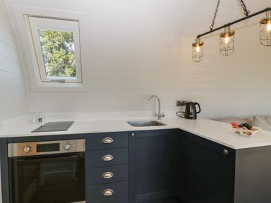 A kitchen with an oven stove sink kettle and window at Leadon View Oak in Upleadon near Newent