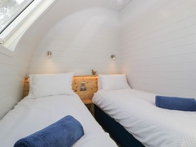A bedroom with two single beds and blue towels at Leadon View Oak in Upleadon near Newent