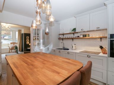 A kitchen with an island and sink at The Wonky Nest in Bowness-On-Windermere