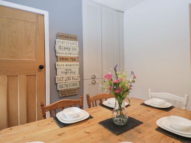 A dining room with a table and chairs at The Wonky Nest in Bowness-On-Windermere