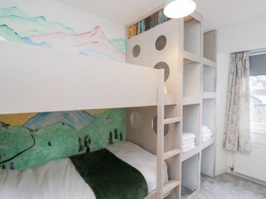 A bedroom with a bunk bed and shelving at The Wonky Nest in Bowness-On-Windermere