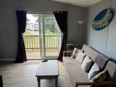 A living room with a sofa and coffee table at Chalet 3 Wipeout in Hayle