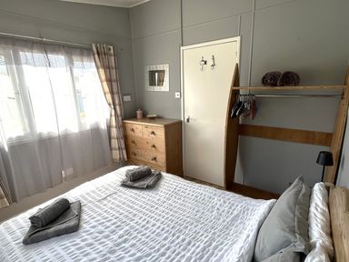 A bedroom with a bed and furniture at Chalet 3 Wipeout Hayle