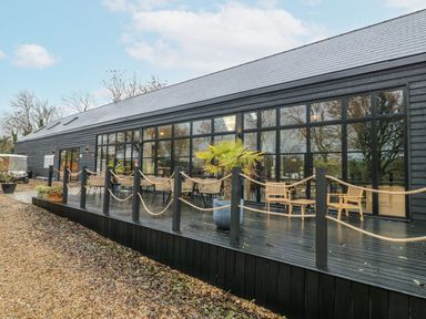 An outdoor seating area with chairs and plants at Badger's Burrow Edith Weston