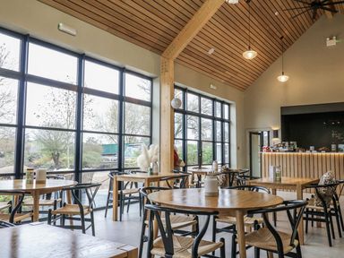 A cafe with tables and a service counter at Badger's Burrow in Edith Weston