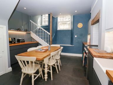 A kitchen with a dining table and chairs at Unicorn Cottage