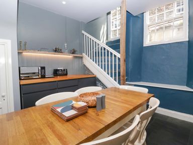 A kitchen with a table and chairs at Unicorn Cottage