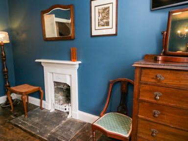 A sitting room with furniture and decor at Unicorn Cottage
