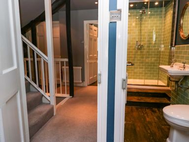 A bathroom with a shower and sink at Unicorn Cottage