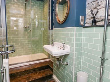 A bathroom featuring a shower and sink at Unicorn Cottage