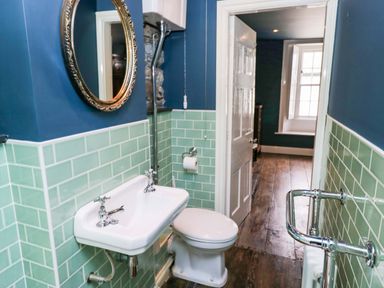 A bathroom with sink and toilet at Unicorn Cottage in 