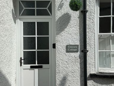 A door with a sign reading Unicorn Cottage at Unicorn Cottage in Ambleside