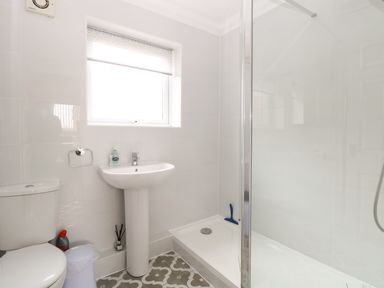 A bathroom with a toilet sink and shower at 102 Waterside Park in Corton