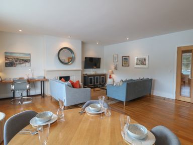 A living room with a sofa, television and desk at 22 Dart Marina Dartmouth