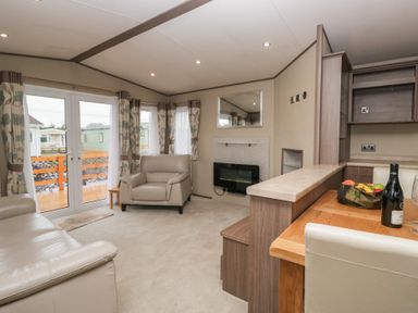 A living room with a sofa and armchair at Aspen in Denny