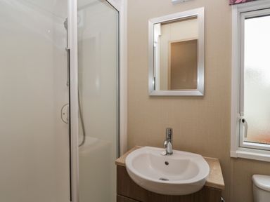 A bathroom with a shower and sink at Aspen in Denny