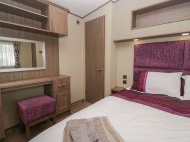 A bedroom with a bed and a desk at Aspen in Denny
