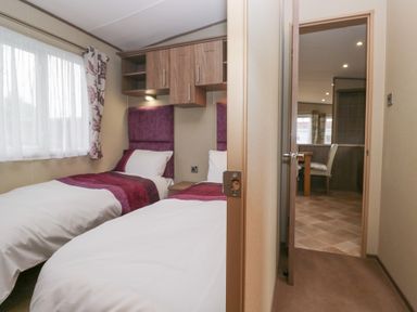 A bedroom with two beds and a window at Aspen in Denny