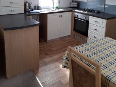 A kitchen with a sink and oven at Oak in Denny