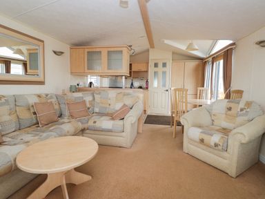 A living room with sofa and dining table at Birch in Denny