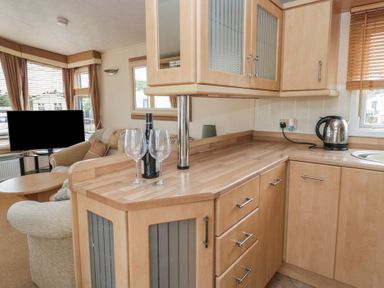 A kitchen with a countertop and television at Birch in Denny