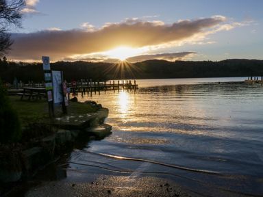 A lake with docks and a grassy area with picnic tables at Esk Pike 9 Skiptory Howe White Cross Bay near Windermere