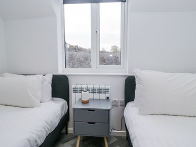 A bedroom with two beds and a window at Claife Flights Bowness-On-Windermere