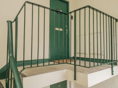 A staircase landing with a door numbered 18 at Claife Flights in Bowness-On-Windermere