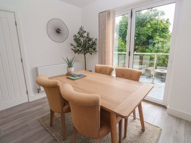 A dining room with a table and chairs at Miramar in St. Ives