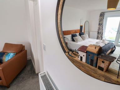A bedroom with a bed and sofa at Miramar in St. Ives