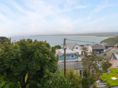 A view of houses and the ocean from a high vantage point at Miramar in St. Ives