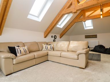 A living room with a sofa and skylights at Miramar St. Ives